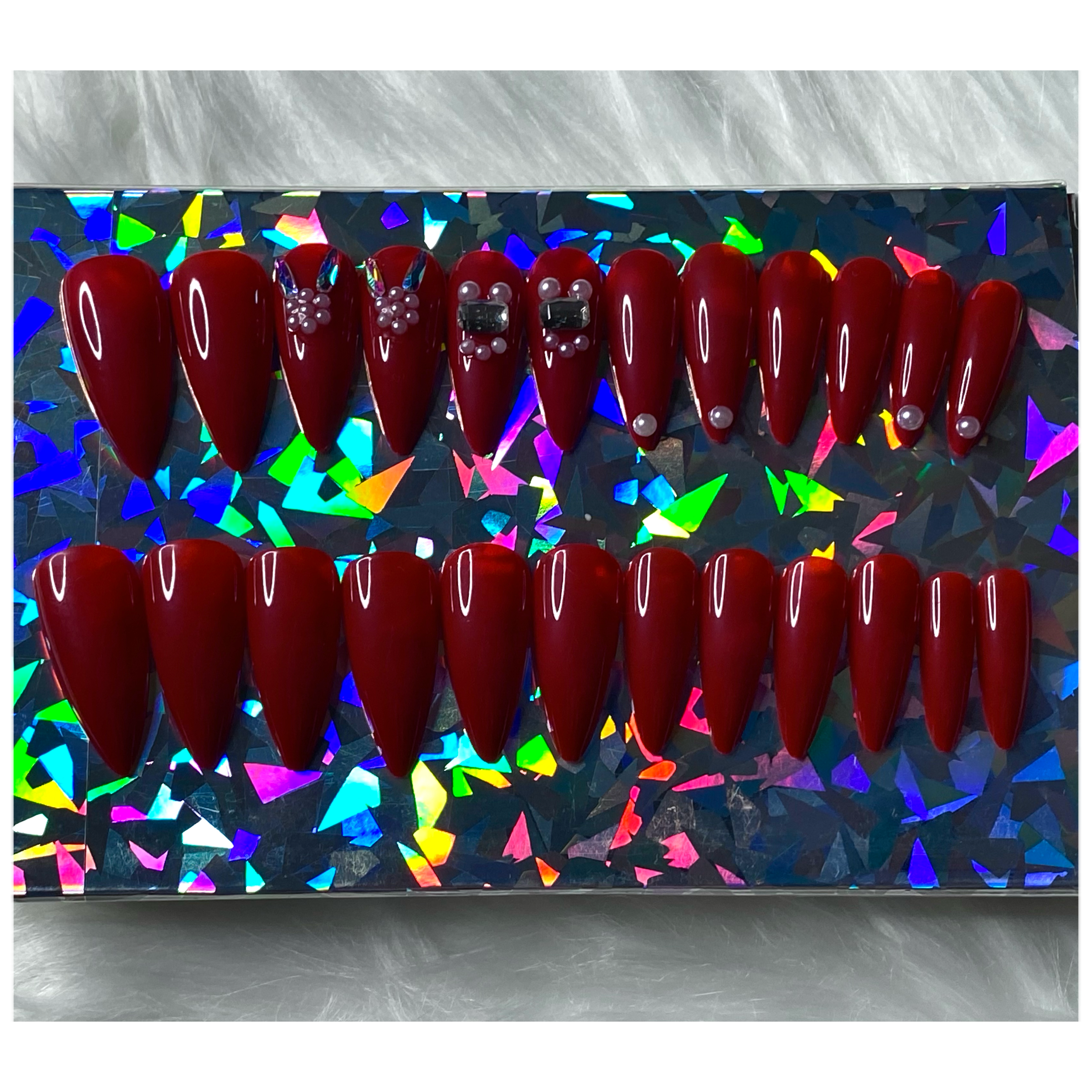 24 piece press on nail set - Deep red medium length stiletto shape press on nails with rhinestone and pearl design